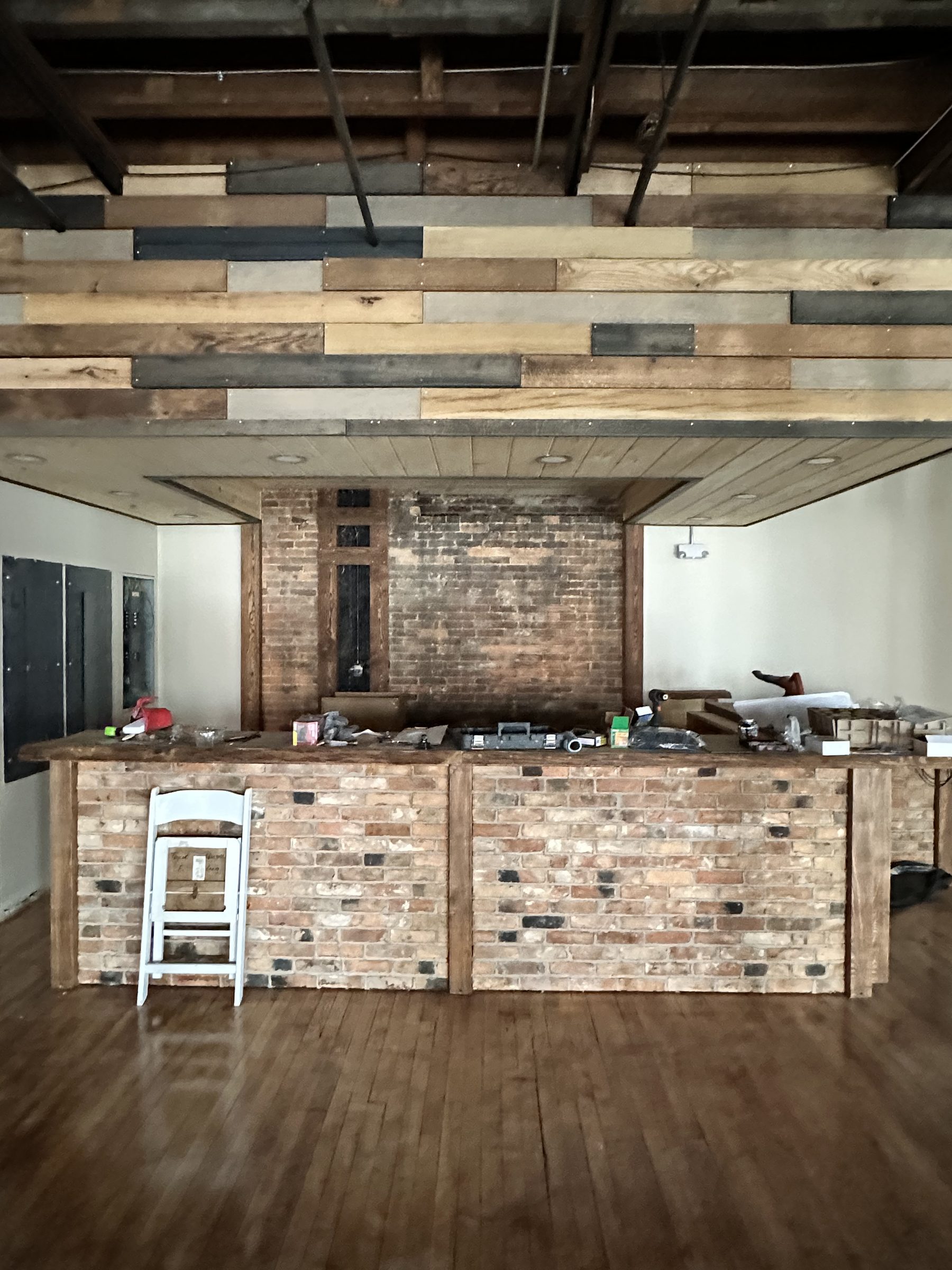 The reclaimed-brick bar under its canopy