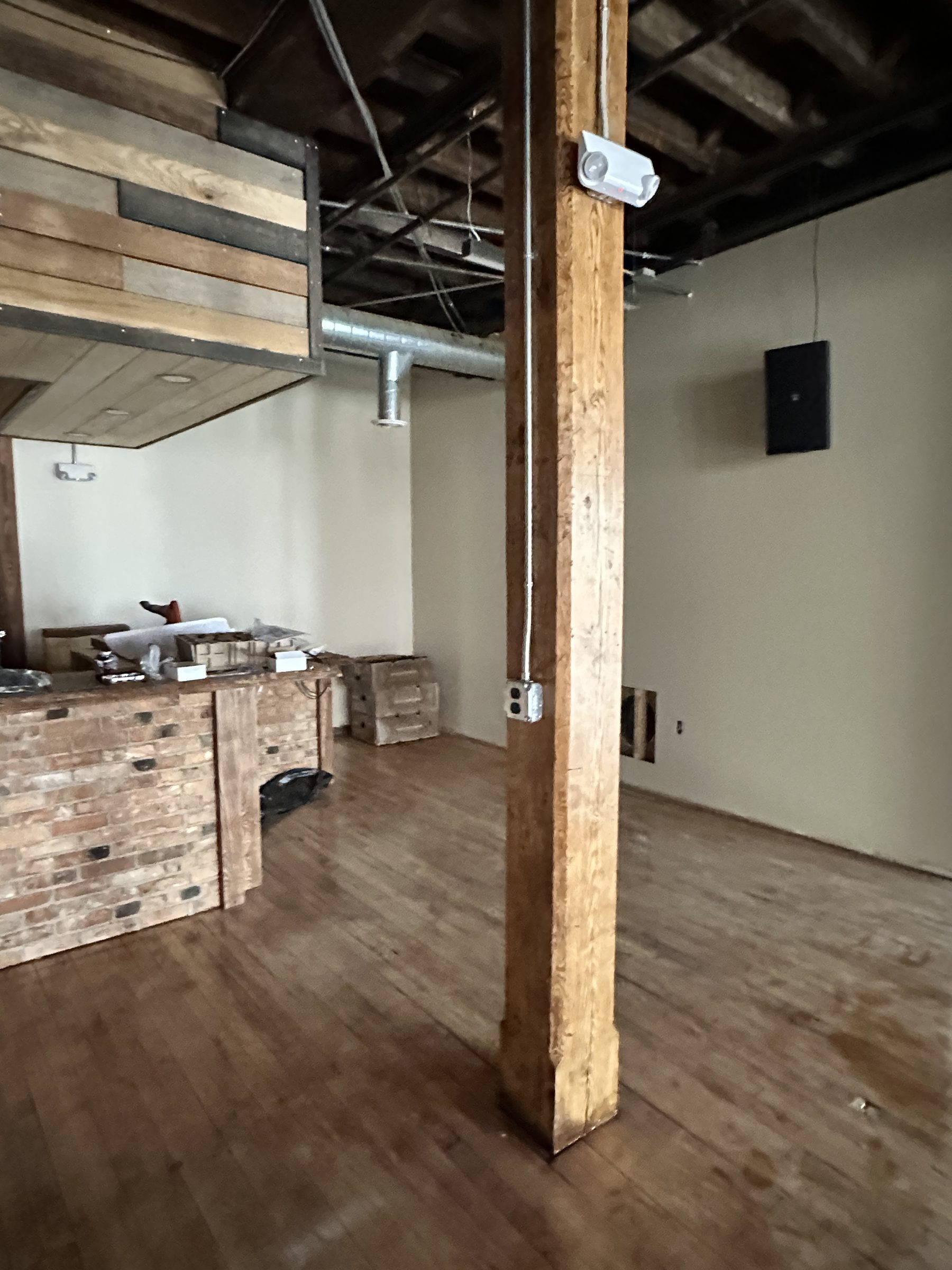 A timber post with the room receding behind it