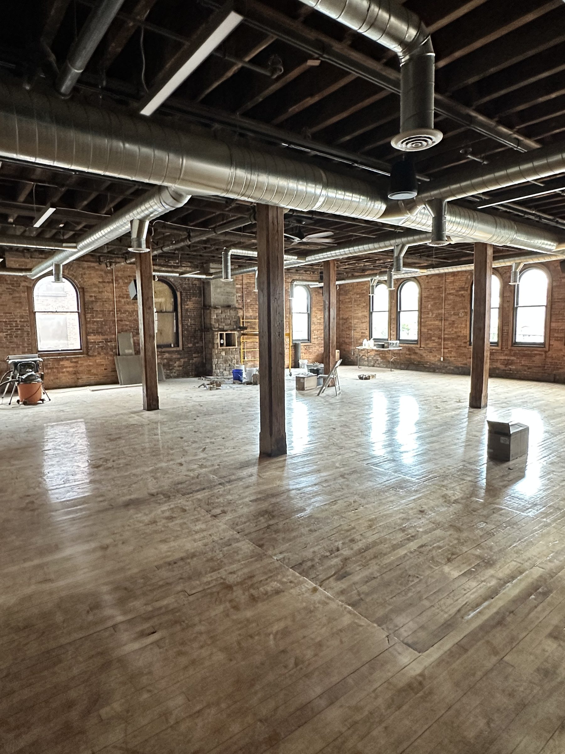 The bright hall under exposed joists and ductwork